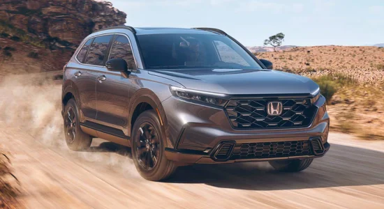 2026 Honda CR-V SUV driving on a dusty desert road, featured by DRIVEN Newmarket as a reliable and versatile compact SUV.