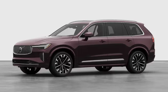 2026 Volvo XC90 Hybrid luxury SUV in deep red displayed in a studio setting, featured by DRIVEN Newmarket as a premium three-row hybrid SUV.