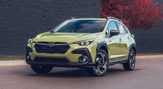 2026 Subaru Crosstrek Hybrid compact SUV in green parked on a city street, featured by DRIVEN Newmarket as a fuel-efficient hybrid crossover for Canadian drivers.