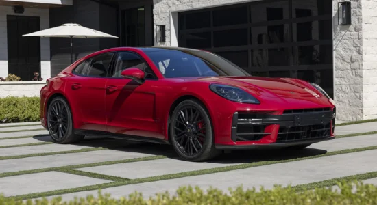 2026 Porsche Panamera luxury sports sedan parked outside a modern home, featured by DRIVEN Newmarket as a high-performance luxury vehicle.