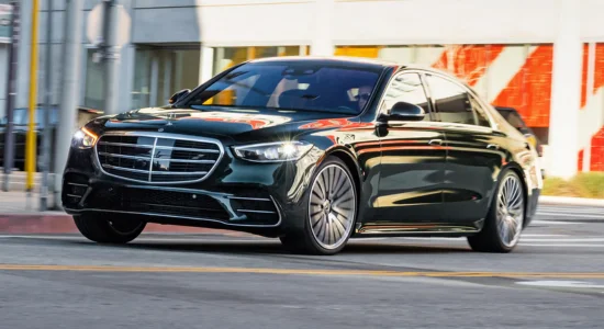 2026 Mercedes-Benz S-Class luxury sedan driving through a city street, featured by DRIVEN Newmarket as a premium flagship luxury vehicle.