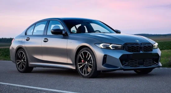2026 BMW 330e plug-in hybrid sedan parked on an open road at sunset, featured by DRIVEN Newmarket as a luxury hybrid performance vehicle.