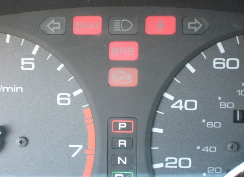 Vehicle dashboard warning lights including SRS, brake, and check engine indicators demonstrating How to Diagnose a Check Engine Light, explained by DRIVEN Newmarket.