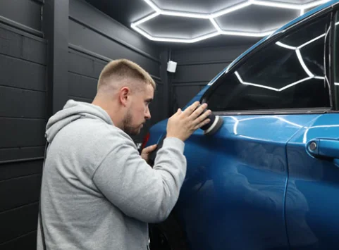 Technician polishing a vehicle exterior to demonstrate What Is Car Detailing, at DRIVEN Newmarket.