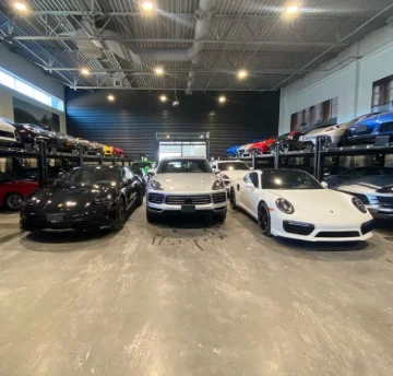 Luxury vehicles inside a showroom prepared for detailing, illustrating How to Prepare for a Car Detailing Service in Newmarket, at DRIVEN Newmarket.