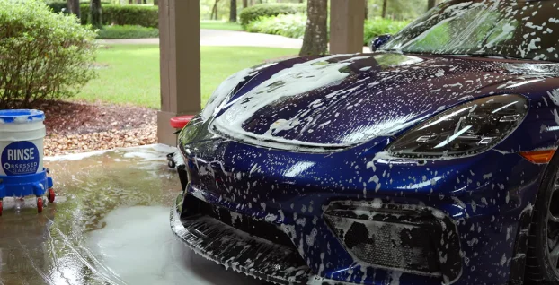 Car covered in foam during washing process, demonstrating Exterior Cleaning and Decontamination at DRIVEN Newmarket.