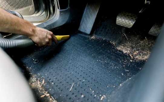 Car interior being vacuumed to remove dirt and debris during Interior Deep Cleaning at DRIVEN Newmarket.