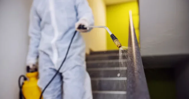 Technician disinfecting surfaces with spray equipment during Interior Surface Sanitization & Odor Removal at DRIVEN Newmarket.