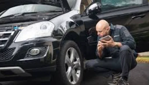 Technician inspecting vehicle exterior and wheel area during Exterior Inspection at DRIVEN Newmarket.