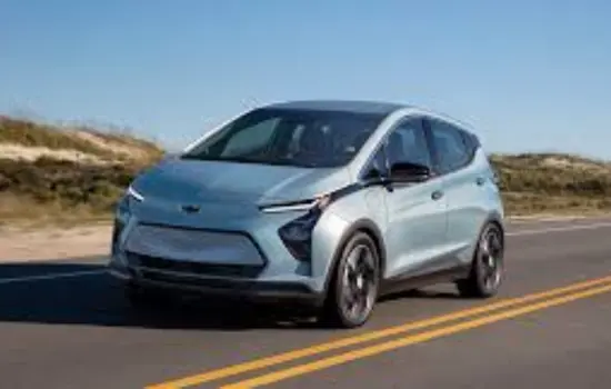 Light blue Chevrolet Bolt EV (2020–2023) electric hatchback driving on an open road, featured by DRIVEN Newmarket.