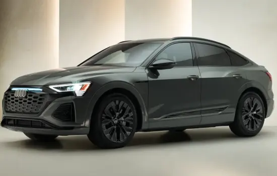 Dark grey Audi e-tron/Q8 e-tron (2019–2023) luxury electric SUV parked in a modern studio setting, featured by DRIVEN Newmarket.