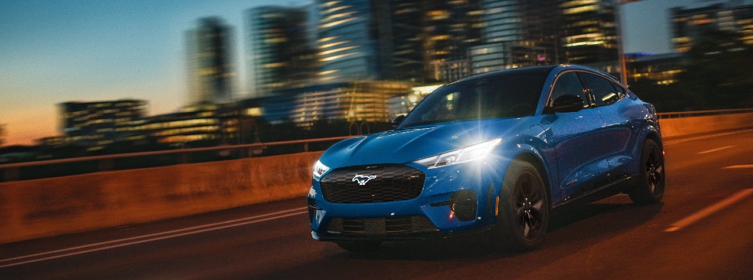 A photo of a 2025 Ford Mustang Mach-E on the road at night.