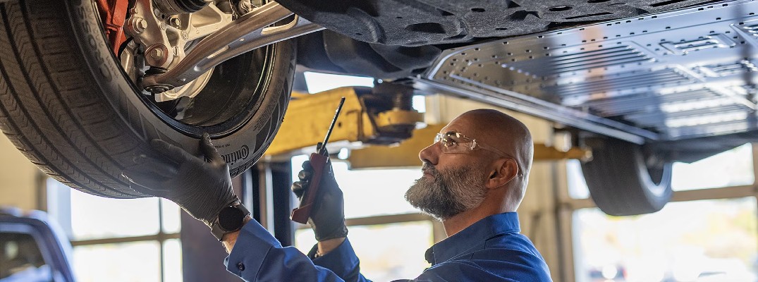 A photo of a person working on a 2025 Mustang Mach-E.