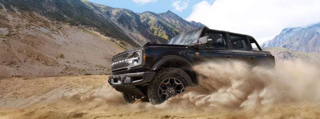 2026 Ford Bronco driving through dirt terrain
