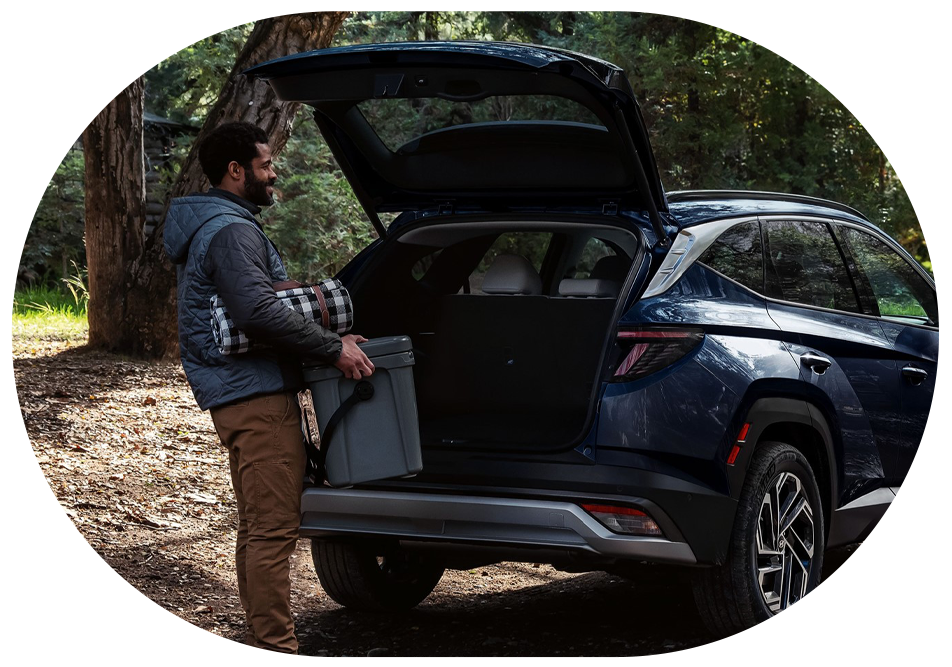 man grabbing a cooler form the back of a hyundai tucson