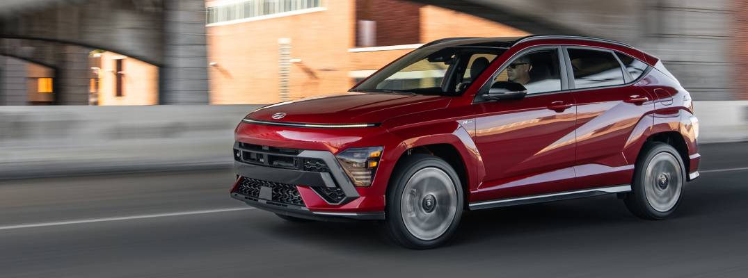 2026 Hyundai Kona driving down road.