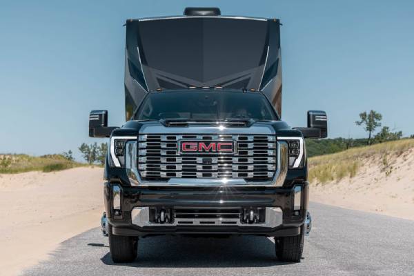 A black 2026 GMC Sierra HD pulls a full size travel trailer. New 2026 GMC Sierra 2500 & 3500 towing and engine specs at Gardner GM in Hope, BC