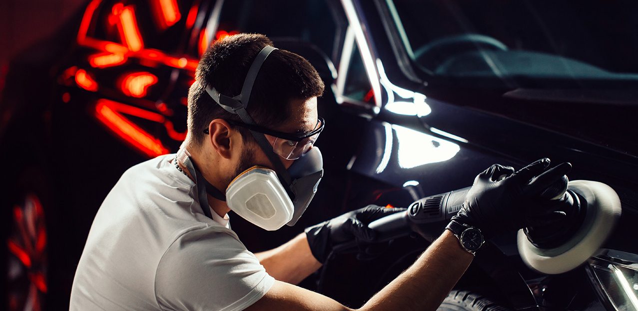Car polish wax. worker hands holding a polisher and polish car
