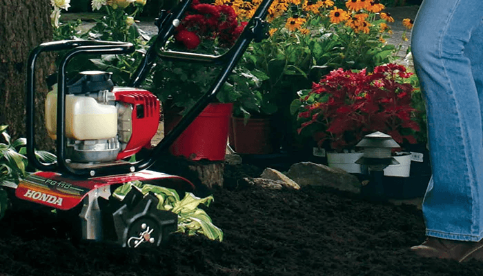 Person using a Honda tiller in their garden