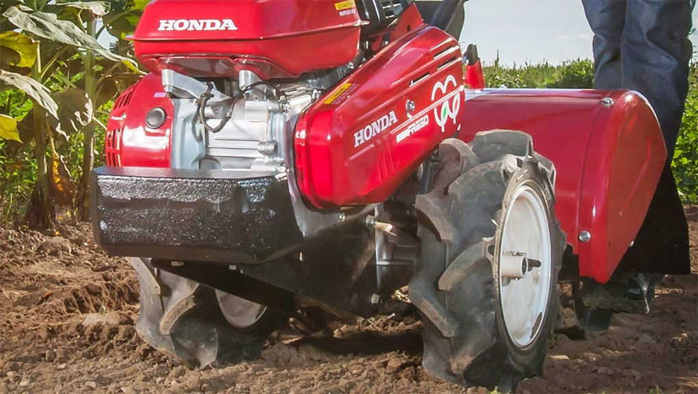 Front of a large Honda tiller in a big field area