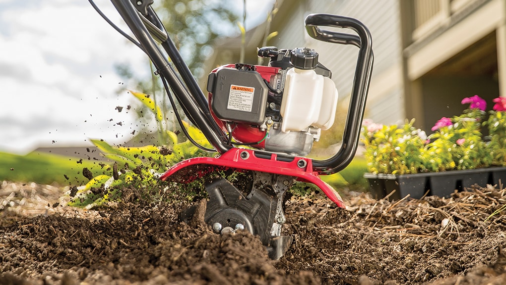 Side close-up of Honda tiller in a garden