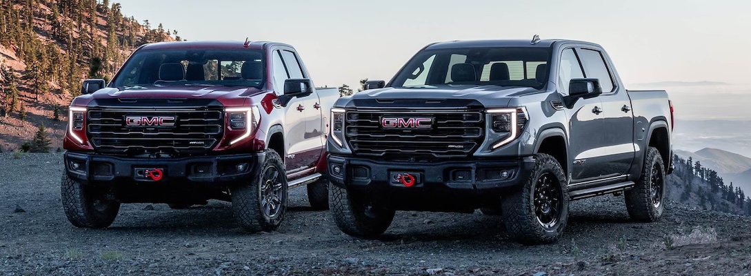 Exterior of two 2025 GMC Sierra 1500 AT4s.