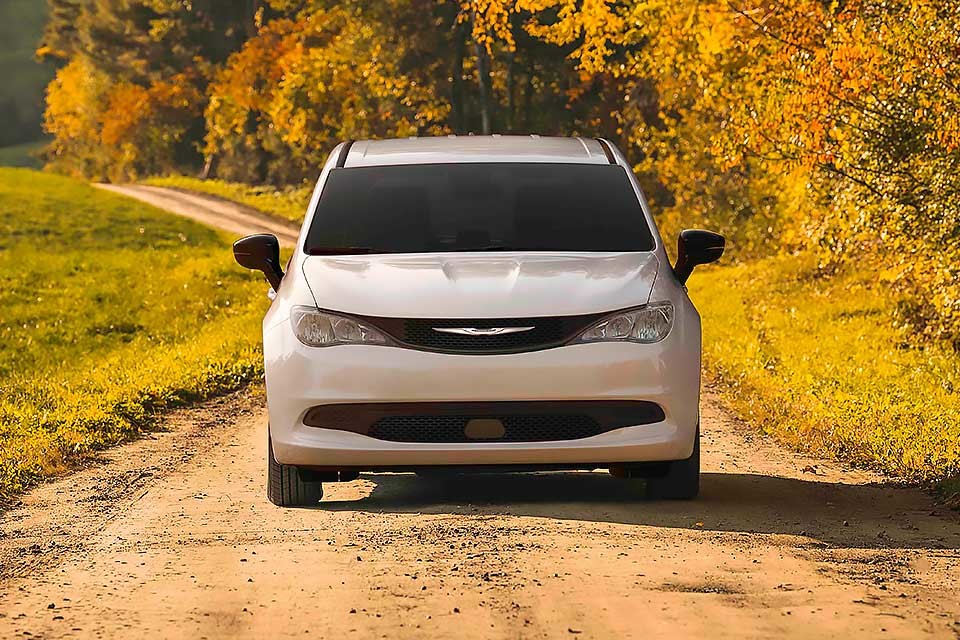 2026 Chrysler Grand Caravan driving down pathway