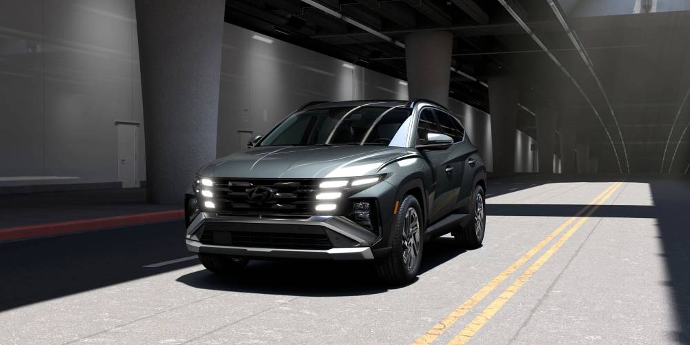 A silver 2026 Hyundai Tucson drives through a tunnel. New 2026 Hyundai Tucson for sale at Gus Brown Hyundai
