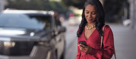 person_standing_on_sidewalk_looking_at_phone.jpg