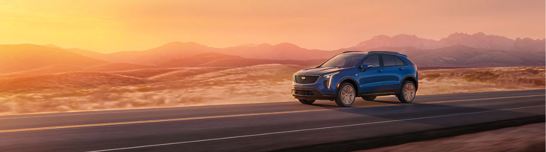 2023 Cadillac XT4 driving down a rural road