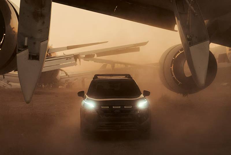 A shadowed 2026 Nissan Rogue drives through extreme sandstorm conditions with its lights on