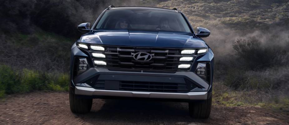 A dark blue 2026 Hyundai Chatham drives towards the camera on a dirtroad