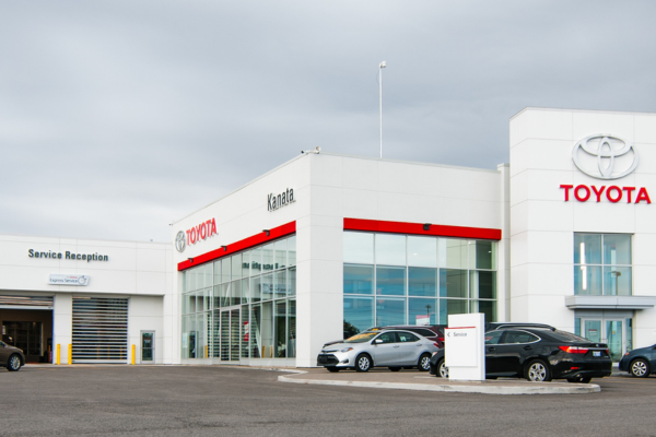 Exterior view of Kanata Toyota dealership with Service Reception and customer parking area.