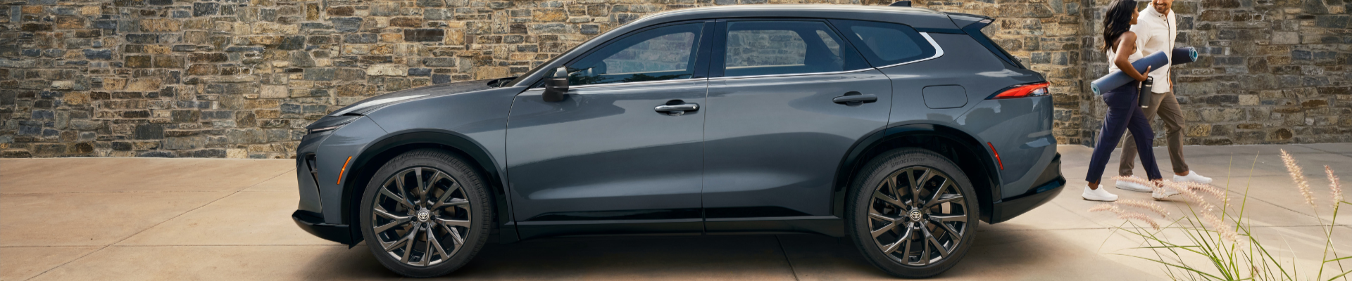 The Toyota Crown Signia displayed in a side-profile view, emphasizing its exterior design and stance.