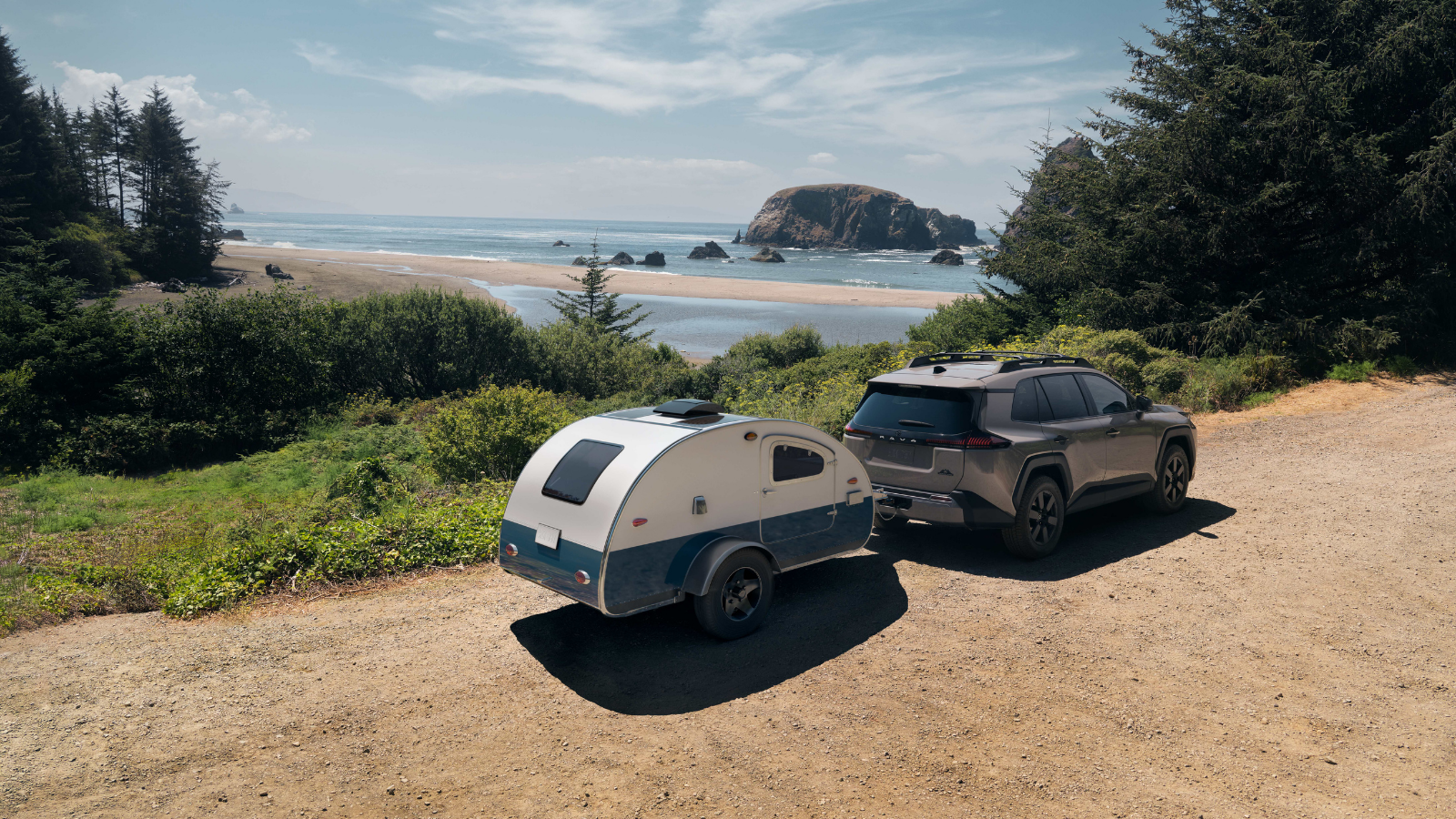 2026 Toyota RAV4 towing a compact camper trailer on a coastal road demonstrating towing capability available at Kanata Toyota in Ottawa