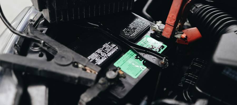 Clamps testing a car battery. Car battery service and replacements at Key Auto Group in Yorkton, SK and Swan River, MB