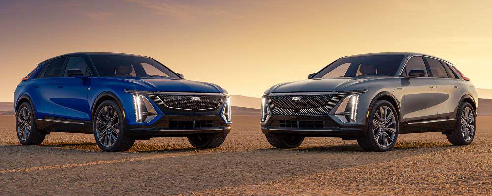 Two 2026 Cadillac LYRIQs are parked in front of a sunset