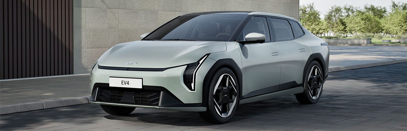 Front side view of EV4 parked next to building