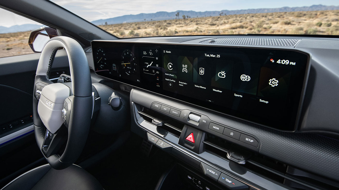 An angled close up of the 2026 Kia K4 Hatchback, showing off its steering wheel and wide infotainment screen