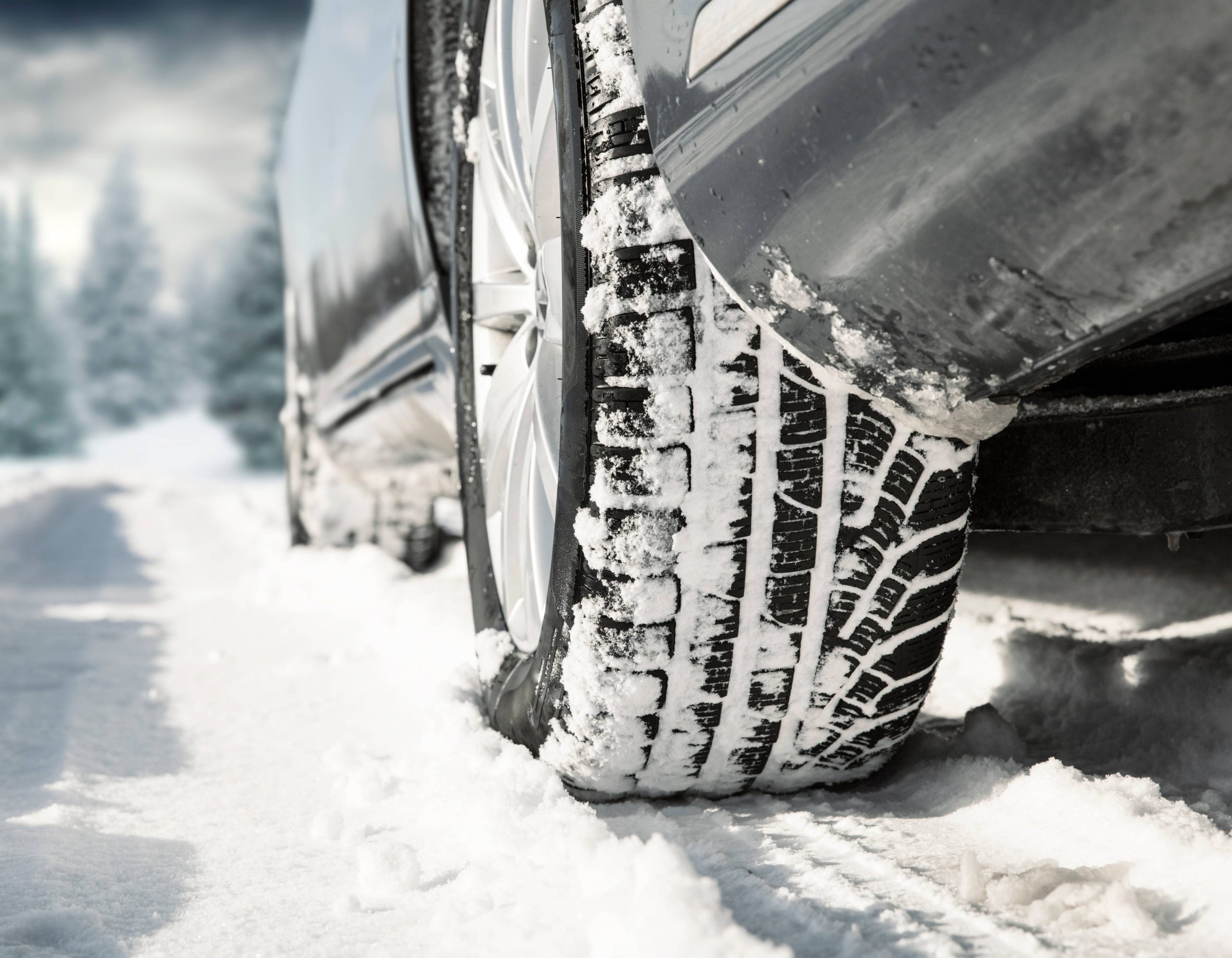 A close up of winter tires caked in snow