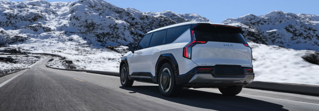 2024 Kia EV9 driving down a winter road