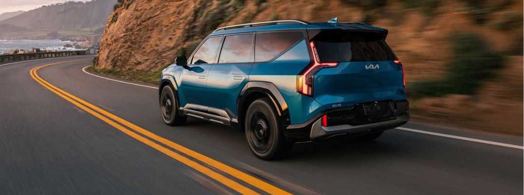 2026 Kia EV9 driving down a curved road