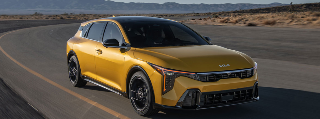 2026 Kia K4 driving down a winding road