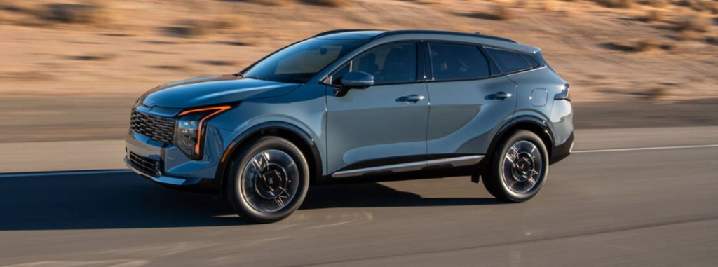 2026 Kia Sportage HEV driving down a rural road