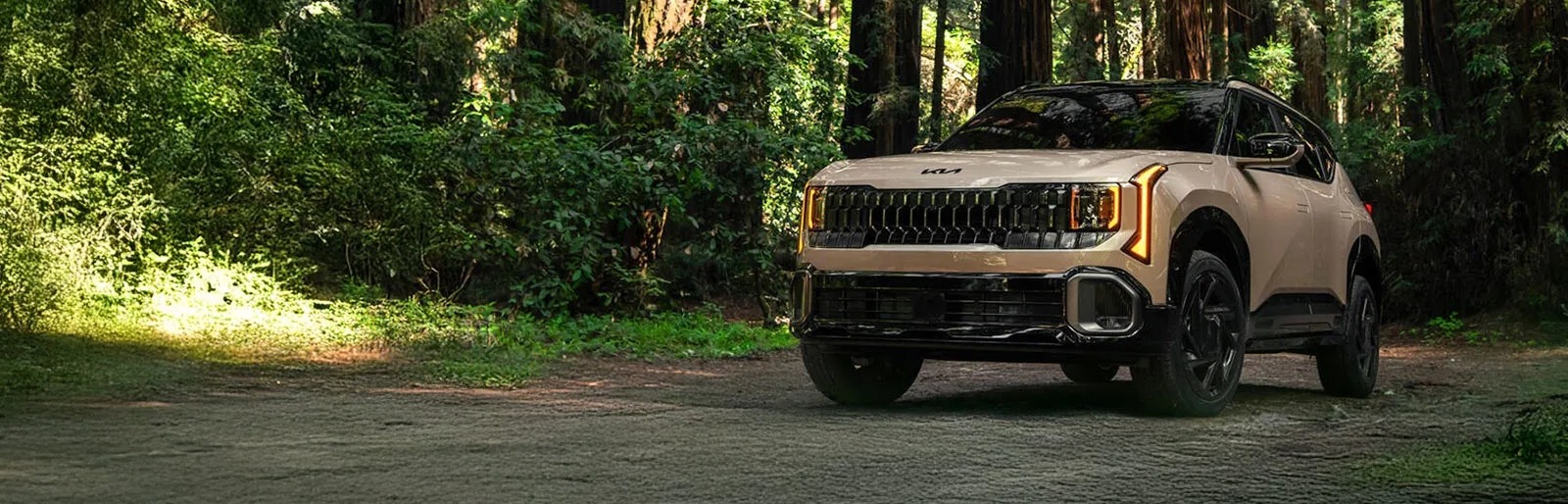 2027 Kia Seltos driving through forest