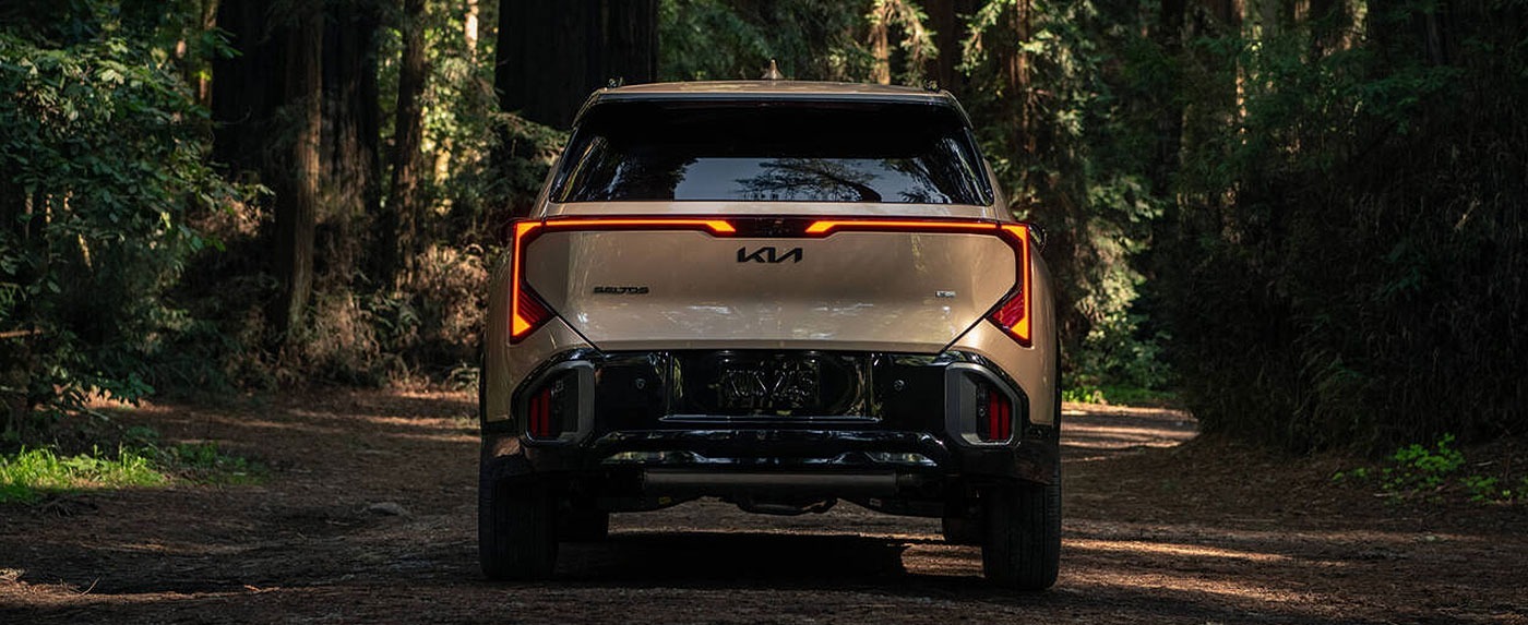 Rearview of 2027 Kia Seltos driving down road