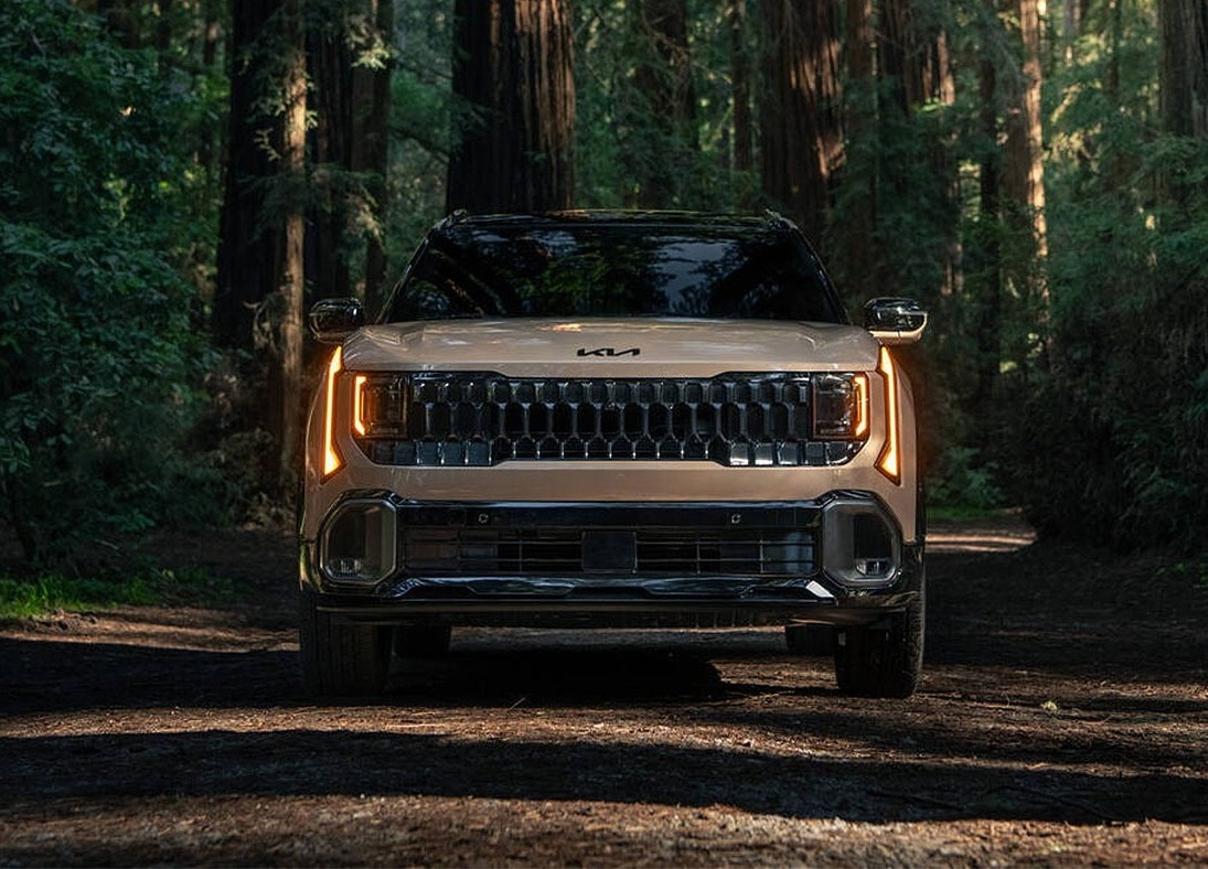 2027 Kia Seltos driving through forest