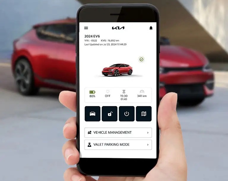 Unknown person holding phone with Kia Connect app open