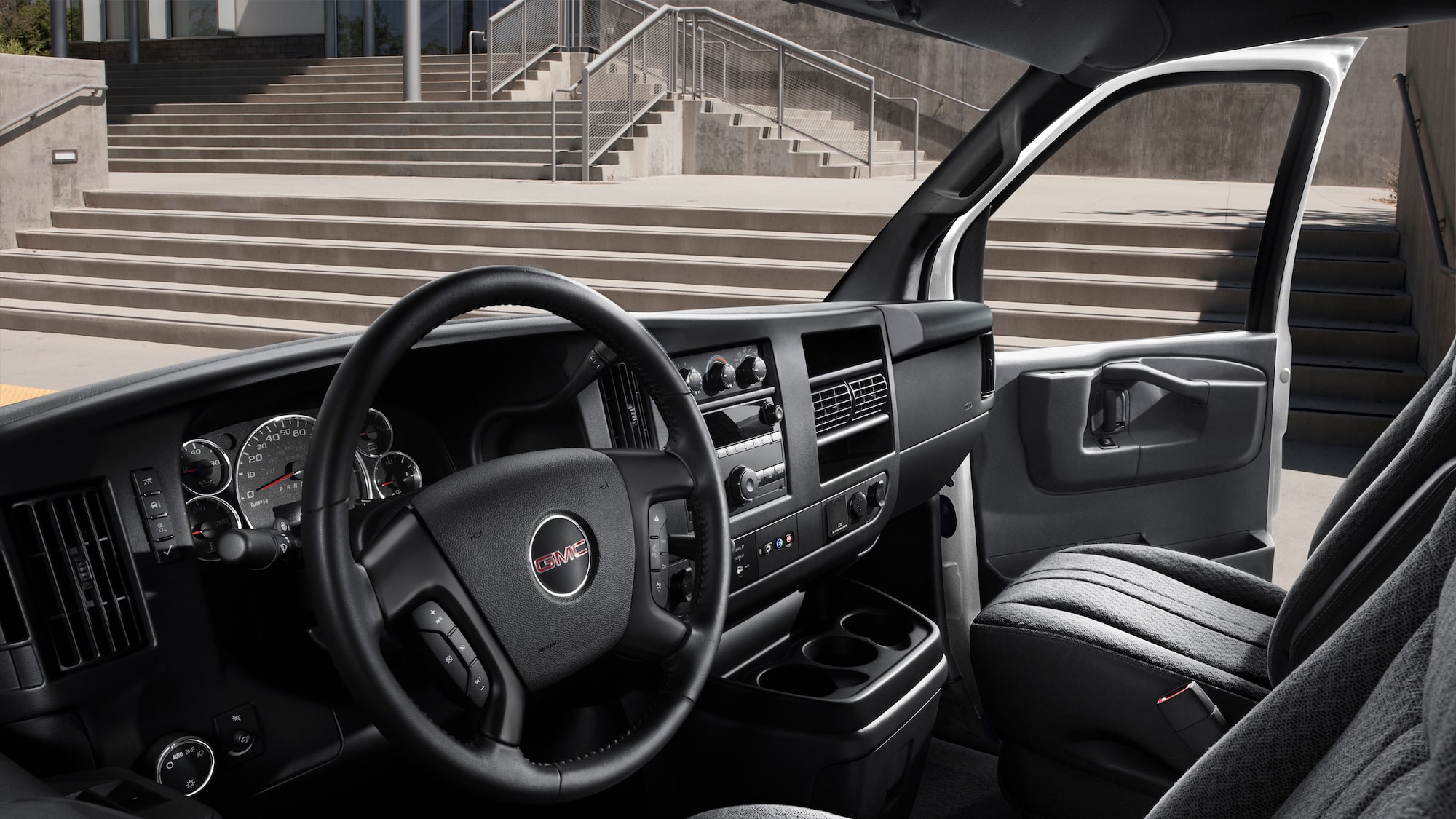 The dashboard, wheel, and windshield of a 2025 GMC Savana Passenger & Cargo Van in Casselman, ON