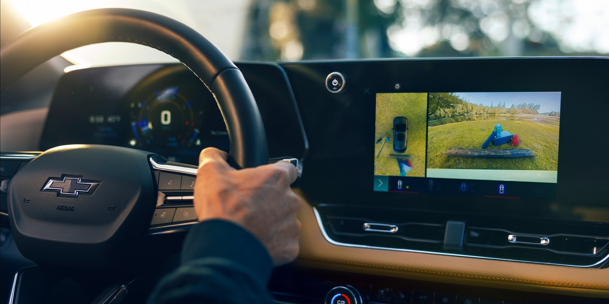 The driver of a 2026 Chevrolet Equinox reaches from the wheel for the central touchscreen on the dashboard, which shows their current surroundings from its onboard cameras